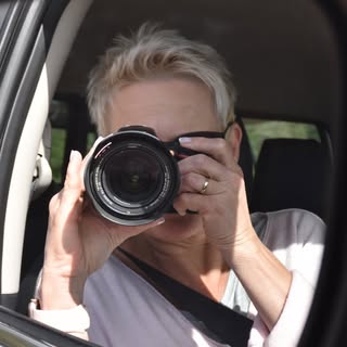 Portrait of Heike, photographer, holding her camera